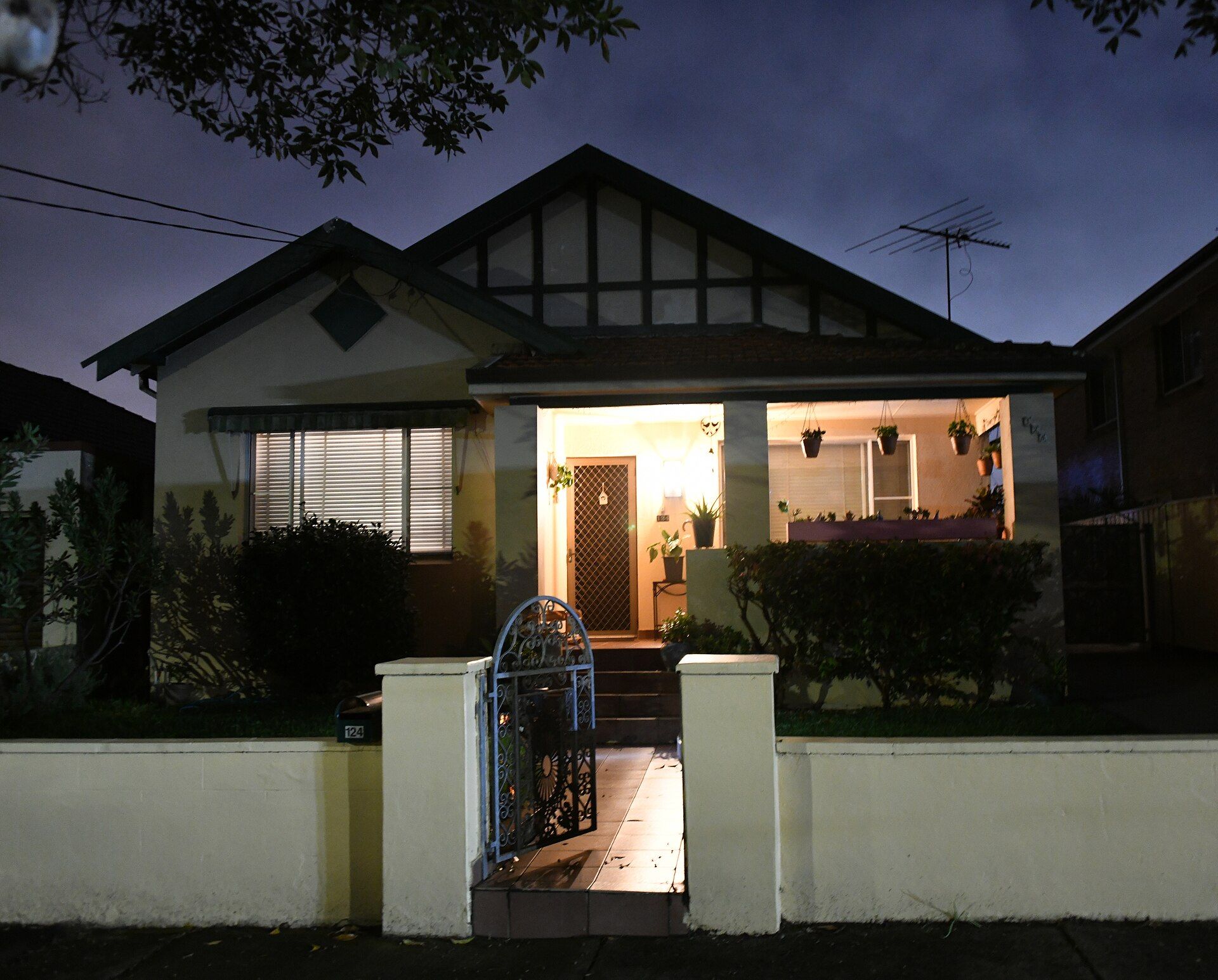 A suburban home at dusk with its windows lit, Kingsford, Sydney